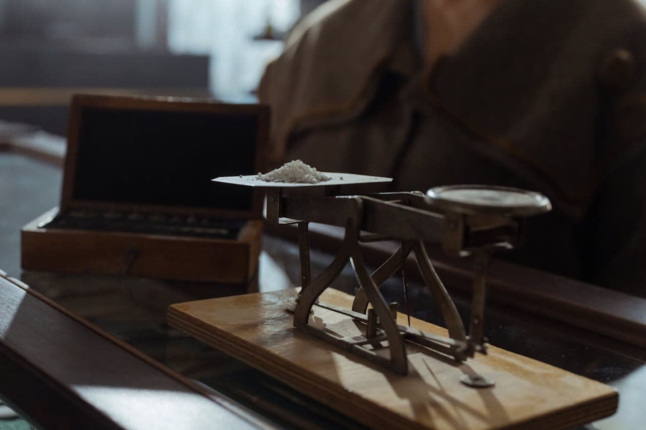 Powder being weighed on a platform balance scale
