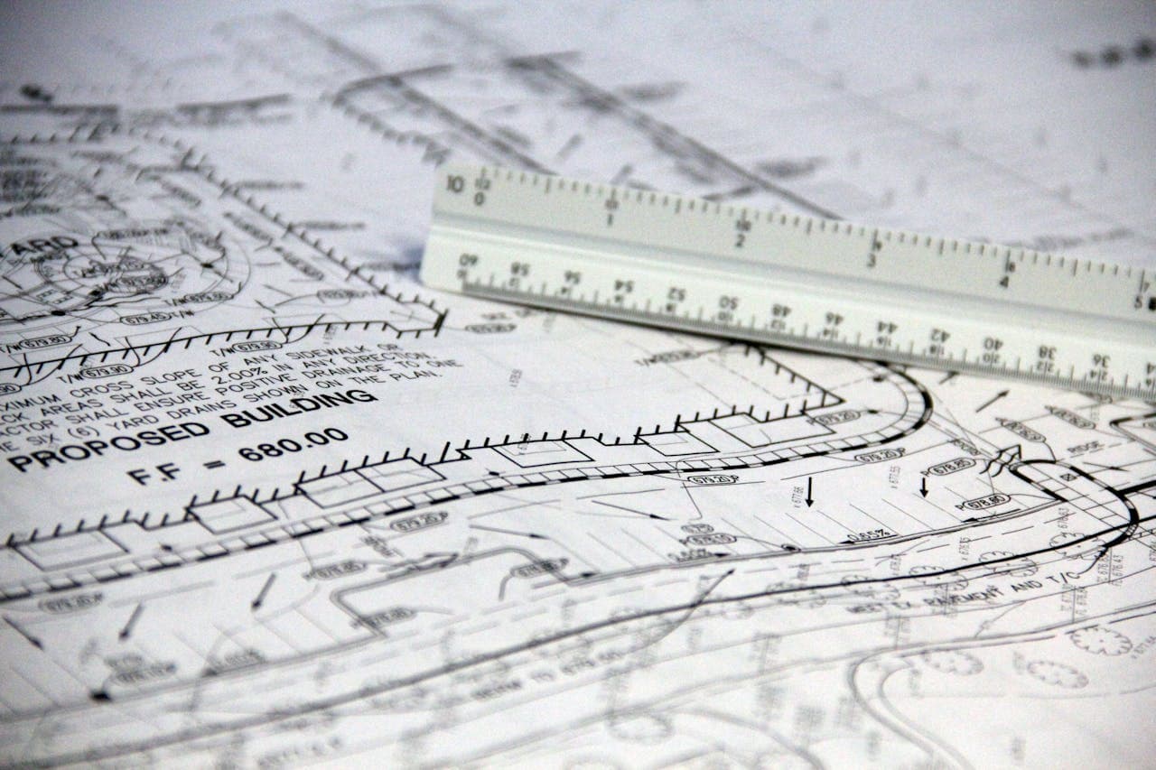A white ruler resting on white printed paper