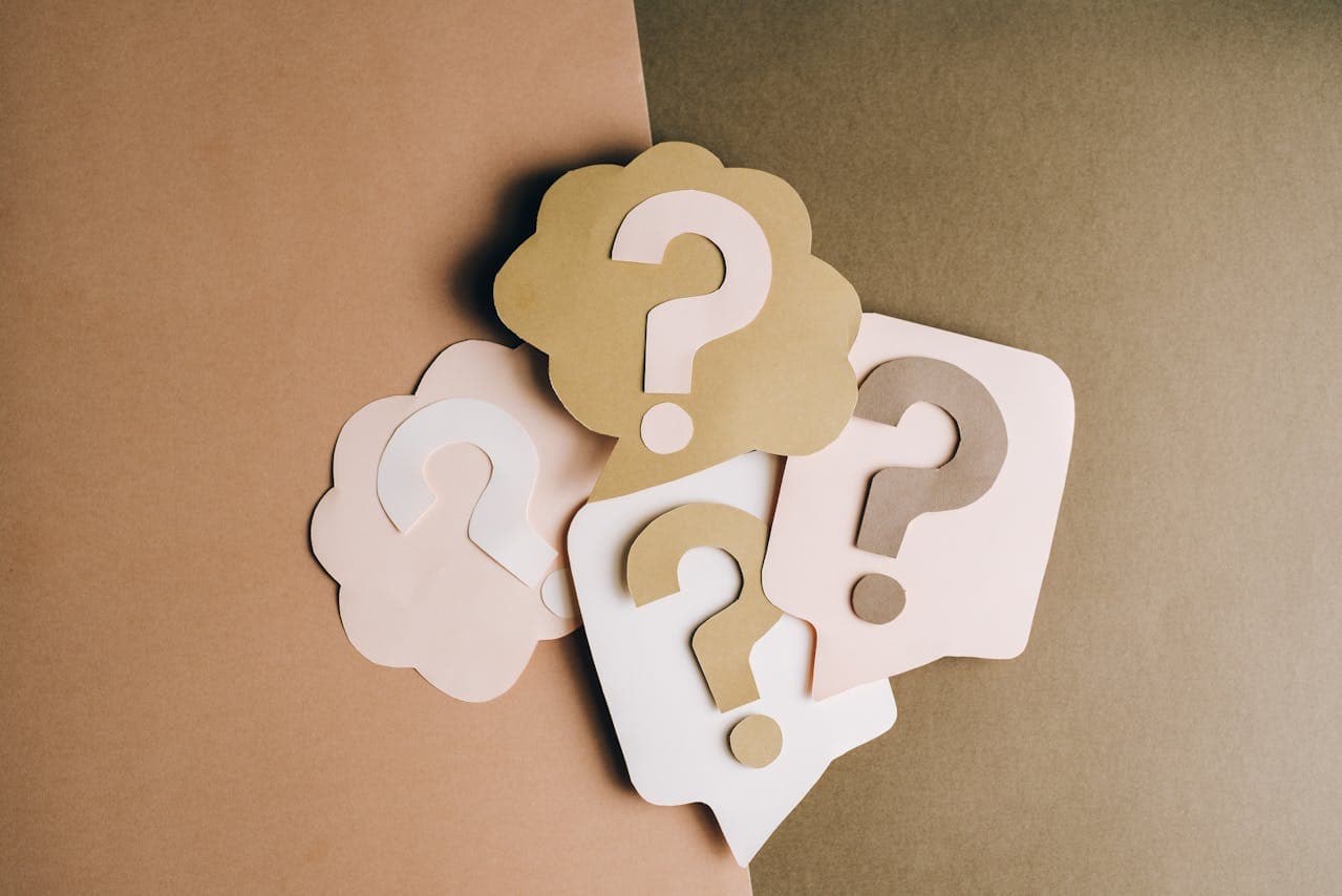 Question marks written on paper craft shapes