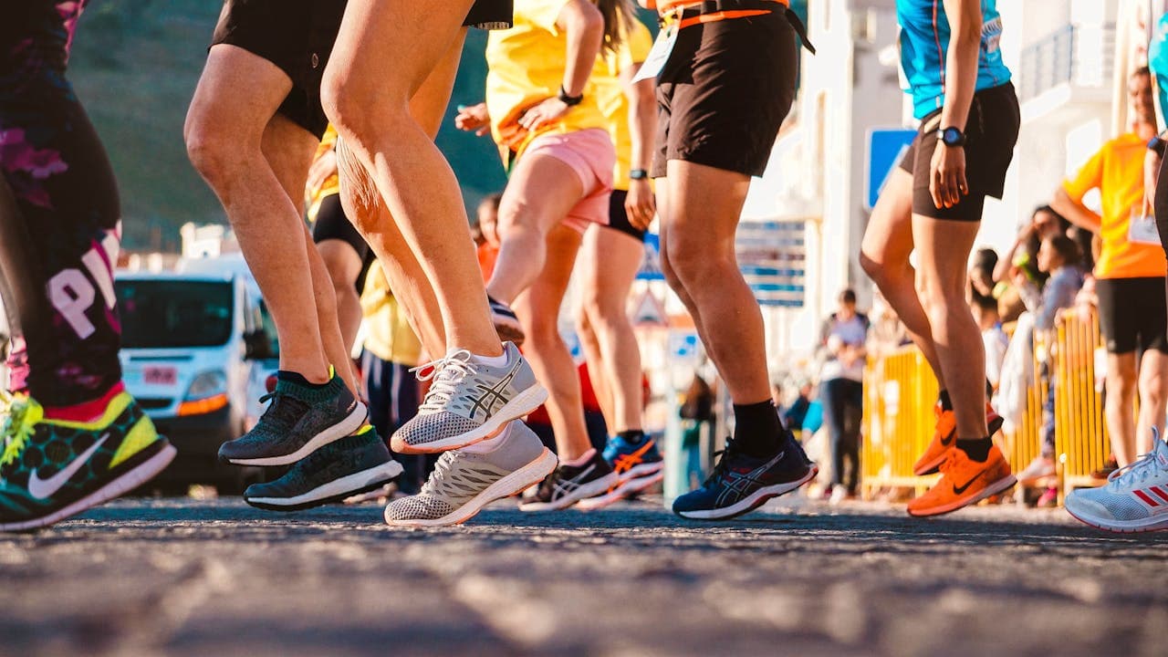 Runners wearing running shoes at the start of a race